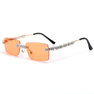 gold and silver jeweled sunglasses with red lens